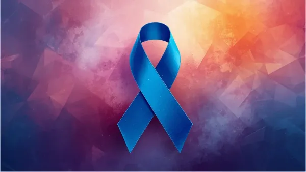 Blue prostrate awareness ribbon on creative pink and purple background.